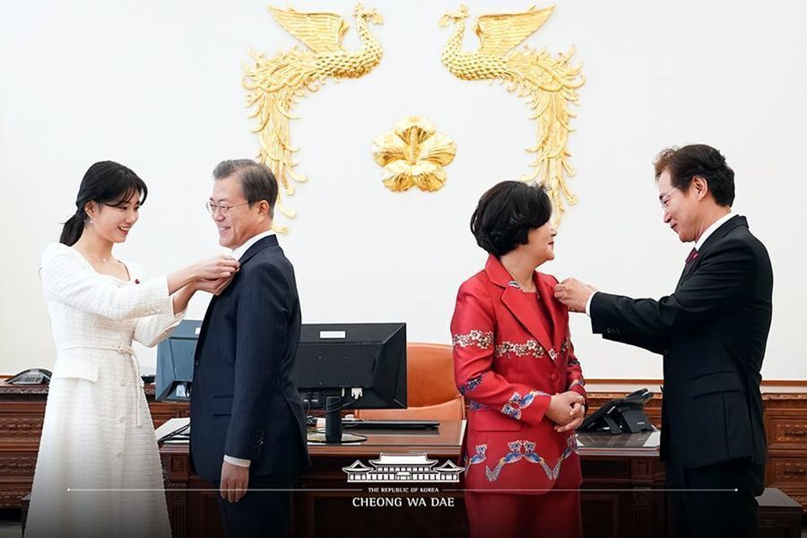 Suzy présente un badge au président Moon Jae In en tant que représentant d'un organisme de bienfaisance